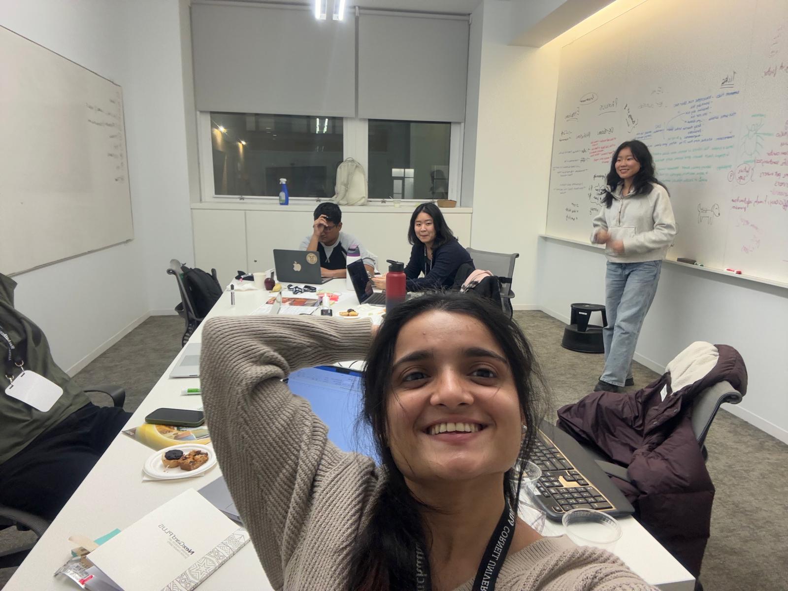 The team brainstorming at the Cornell hackathon